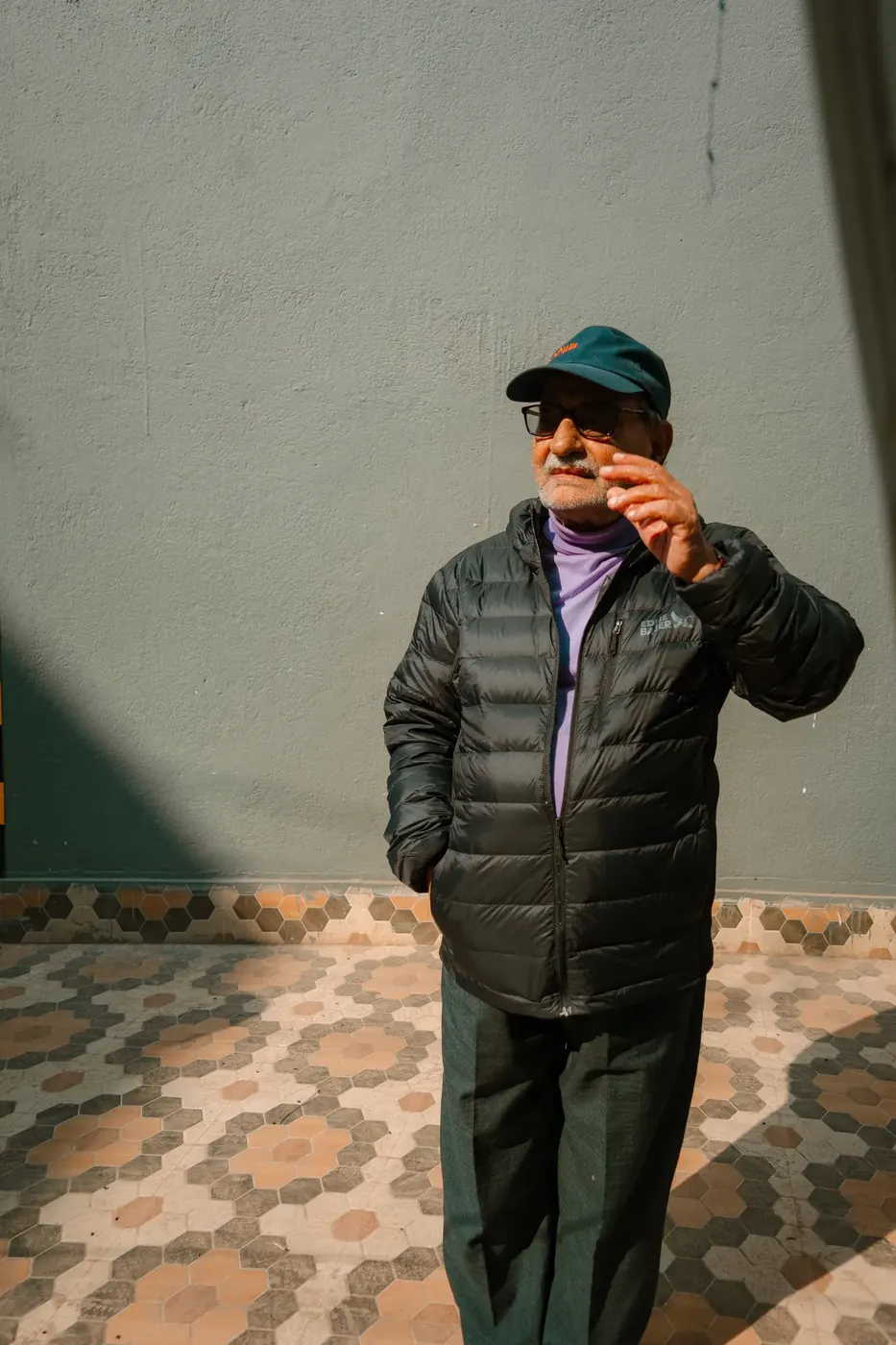 A person photographed against a geometric wall