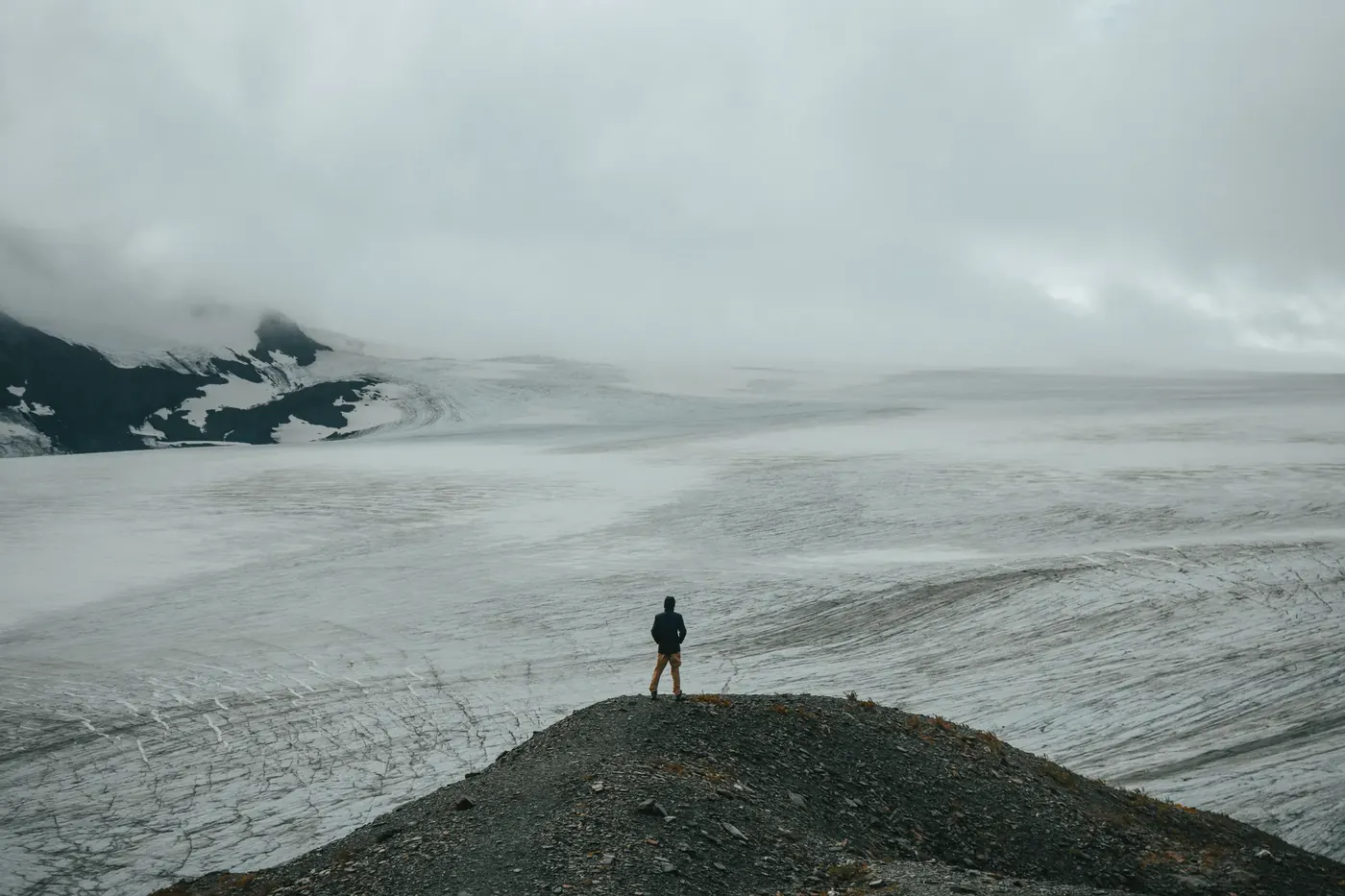 A lone figure overlooking a vast glacier