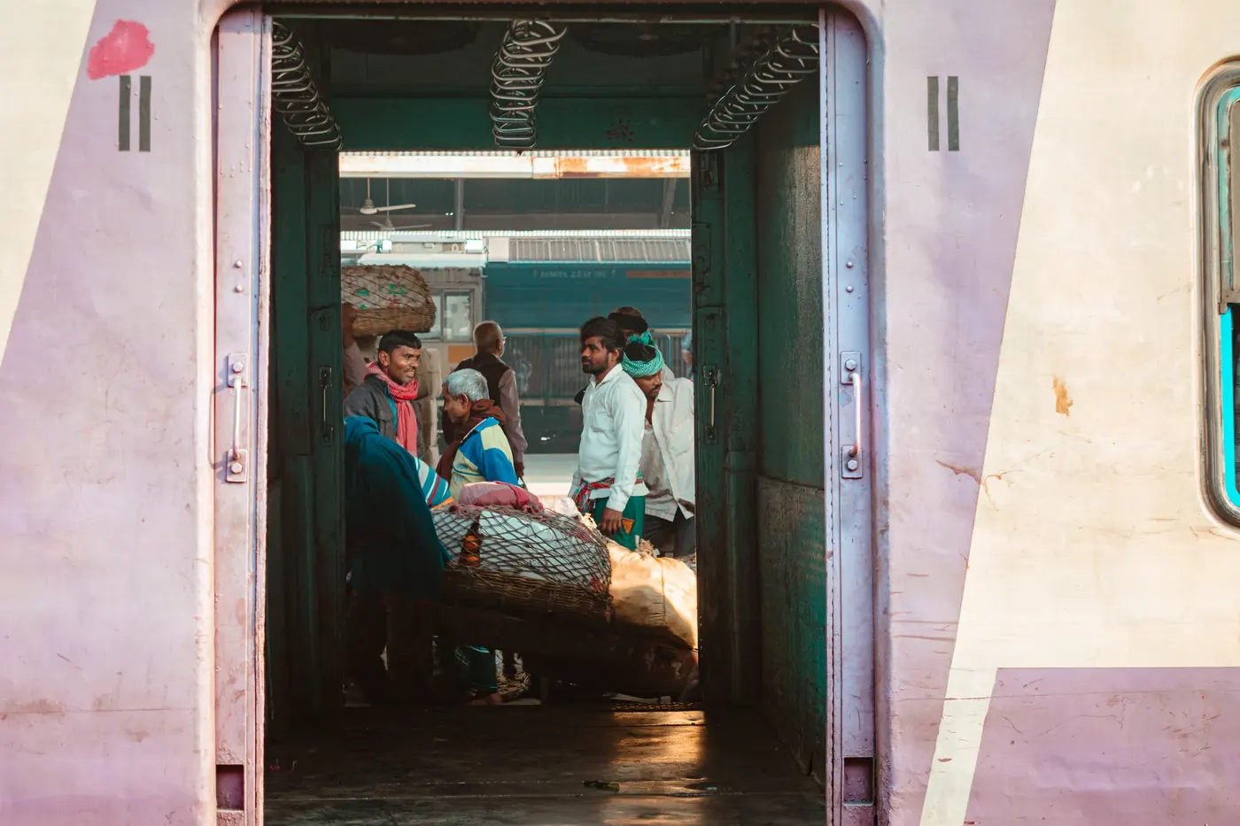 A traveler standing in the open doorway of a train