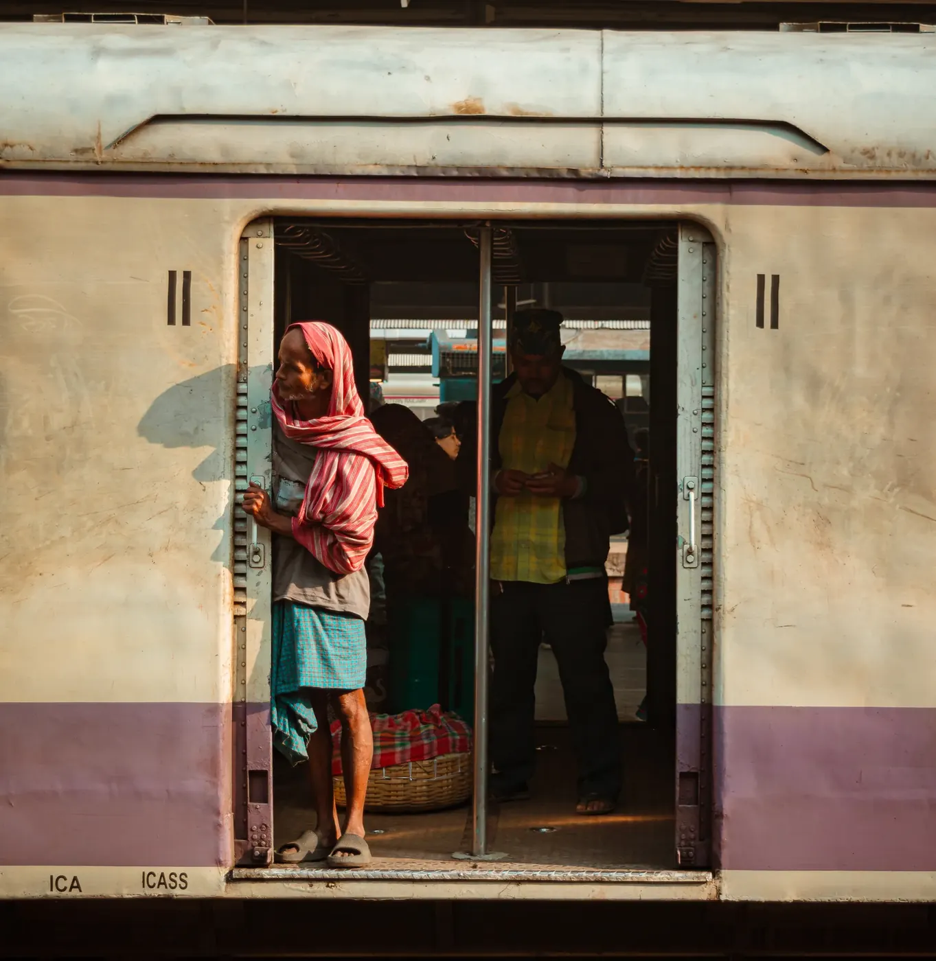 A traveler framed by the doorway of a railway car