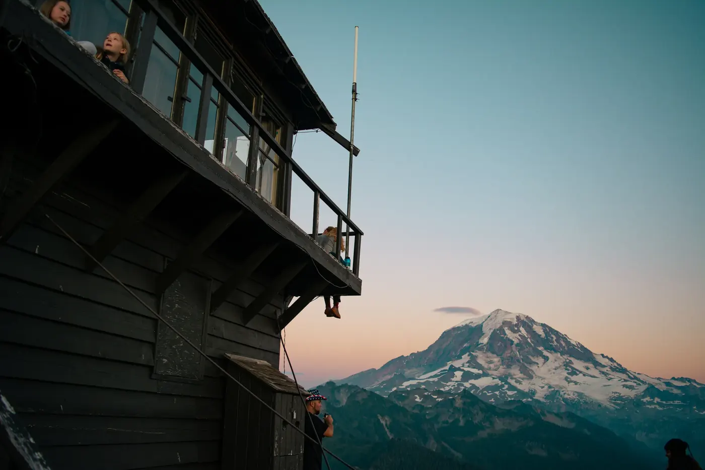 A mountain seen beyond the edge of a dark building
