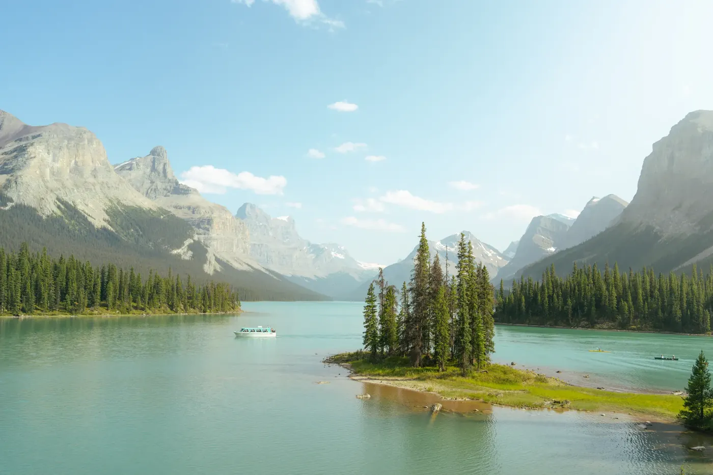 A small evergreen island in a pale mountain lake