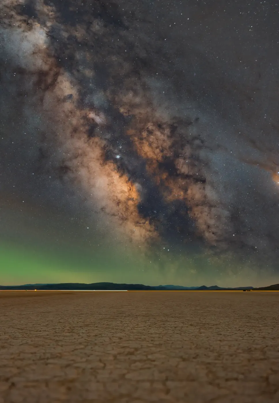 The Milky Way and aurora above a distant horizon