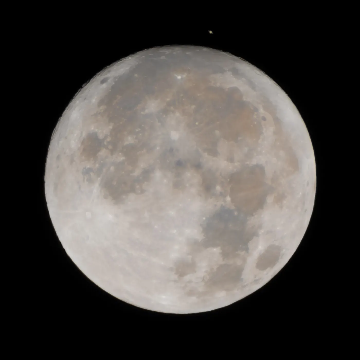 Saturn emerging above the detailed lunar surface during an occultation