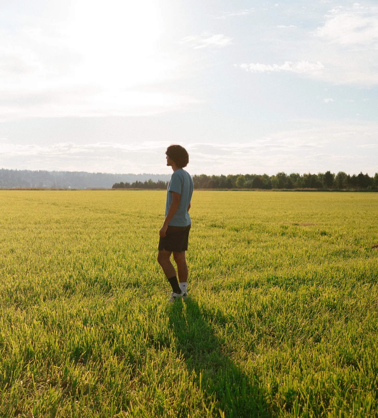 Adrish standing in a sunlit field